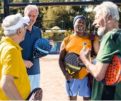 Group of retirees chatting after a pickleball game