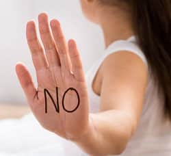 Person with "NO" written on their palm